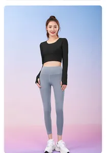 Detailed view of women's black long-sleeve crop top and blue-grey nude feel yoga leggings
