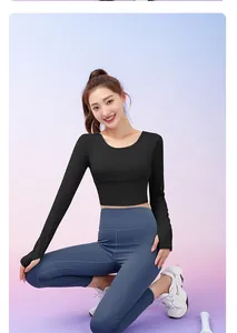 Asian model posing in black long sleeve crop top and blue high waist yoga leggings