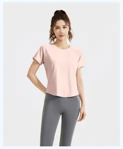 High-quality detail of the pink short-sleeved sports T-shirt and grey leggings