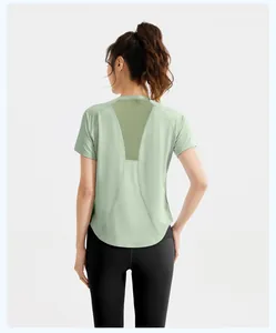 Back view of women's fitness top with breathable mesh panel and black leggings set.