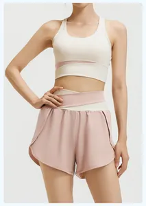 Close-up detail of a pink and beige color-block sports bra and high-waisted yoga shorts set