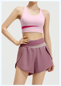Detailed view of women's two-piece pink sports bra and purple running yoga shorts set
