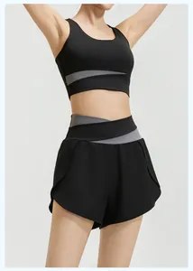 Close-up of black and grey two-piece yoga set with crisscross waist details