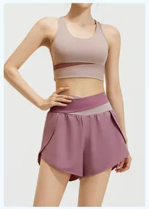 Two-piece yoga sports set featuring mesh insert bra and layered high-waisted shorts