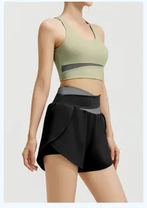 Detail of women's yoga set featuring light green sports bra and black athletic shorts.