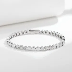 Macro detail of S925 silver bubble dot bracelet with sparkling pavé-set circular links.