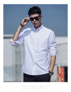 Close-up detail of men's white long-sleeve Oxford shirt featuring a button-down collar