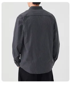 Back view detail of a men's black and white vertical striped long sleeve cotton shirt.