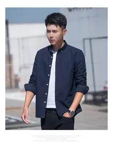 Classic navy blue long-sleeved Oxford shirt for men in an outdoor lifestyle shot.