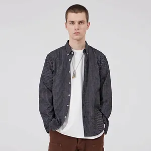 Professional studio shot of a men's casual grey striped cotton shirt on model
