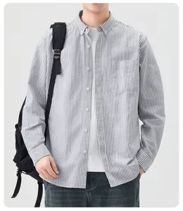 Macro view of men's striped cotton shirt with button-down collar and chest pocket.