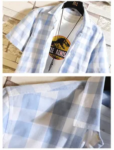 Close-up of the light blue and white checkered fabric and shoulder seam on a men's shirt.