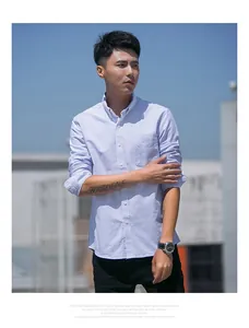 Detail shot of men's blue striped oxford shirt worn by model outdoors