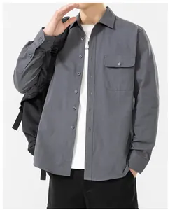 Detail of a grey pure cotton long-sleeved shirt for men featuring a practical chest pocket.