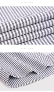 Close-up detail of a striped Oxford long-sleeve shirt fabric texture and hem.