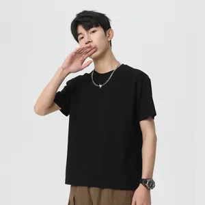 Loose fit black men's short sleeve cotton t-shirt worn by model in studio setting