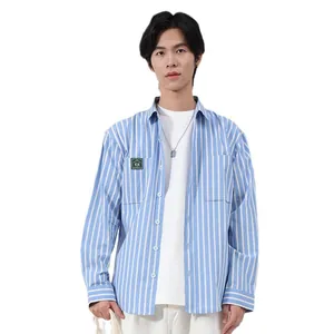 Men's light blue vertical striped long sleeve shirt with chest pocket patch detail