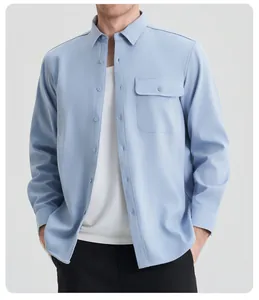 Close-up view of a light blue men's long sleeve shirt featuring a chest pocket detail