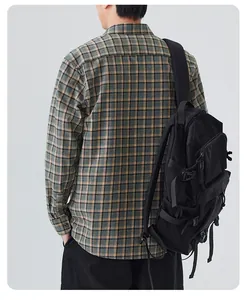 Detailed back view of a casual green plaid long-sleeve shirt for men with a backpack