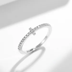 Close-up view of a S925 sterling silver cross ring set with sparkling pavé moissanite stones