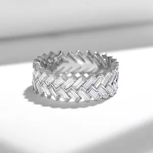 Close-up of eternity band ring with double row baguette-cut stones in silver finish