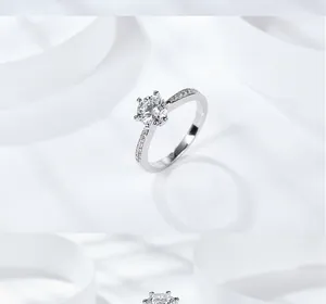 Macro view of six-prong moissanite crown ring with pavé side stones in 925 silver