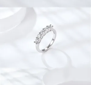 Close-up detail of a 925 sterling silver ring with five sparkling moissanite stones