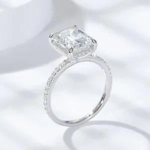 Side view of a 4 carat emerald cut moissanite ring with halo and pavé band
