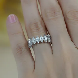 Detailed macro view of marquise-cut moissanite stones on a silver-plated eternity ring band