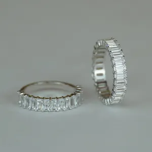 Detailed view of 2x4mm emerald cut moissanite eternity rings with brilliant sparkling stones.