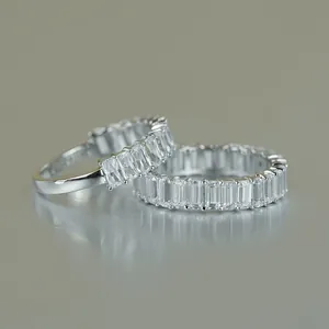 Macro view of D color 2x4mm emerald-cut Moissanite stones on silver eternity ring