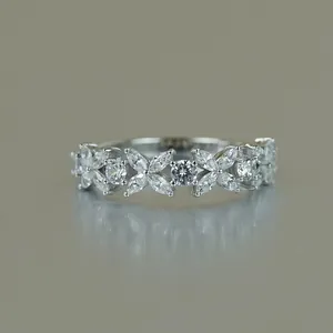 Marquise moissanite lucky clover half eternity ring in 18K white gold plated silver.