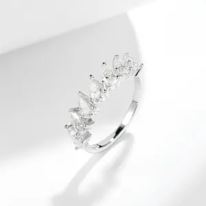 Detailed macro view of silver half-eternity ring featuring seven pear-shaped moissanite stones