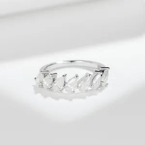 Detailed macro view of 3*4mm pear-cut D color moissanite half eternity ring in silver
