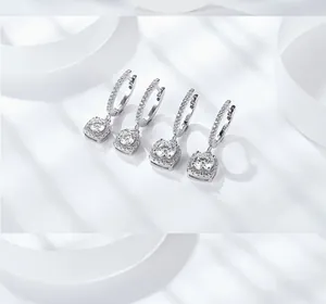 Detailed close-up of S925 sterling silver hoop earrings with princess cut moissanite