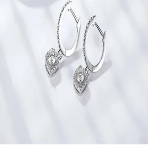 Close-up detail of sterling silver hoop earrings featuring D color princess square moissanite