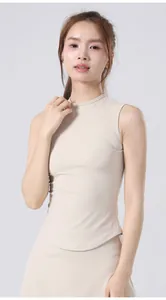 Close-up of a women's slim-fit beige sleeveless yoga top featuring a high neckline.