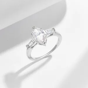 Detail view of a stunning marquise moissanite three-stone engagement ring in 925 silver