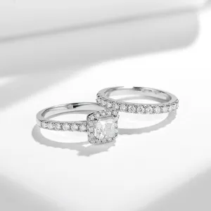 Detalle de cerca de un conjunto de anillos de compromiso de moissanita corte princesa.