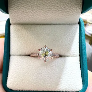 Detailed close-up of a 7mm hexagonal moissanite engagement ring in a teal jewelry box