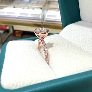 Close-up side view detail of a 7mm hexagonal moissanite engagement ring in rose gold plated silver