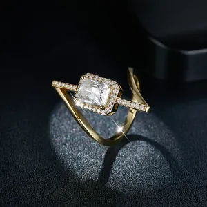 Close-up of a 2ct radiant cut moissanite in an asymmetric gold-plated silver halo ring