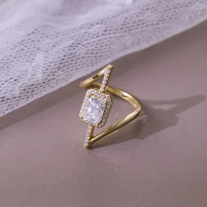 Close-up of radiant cut 2ct moissanite ring with asymmetric gold plated silver band