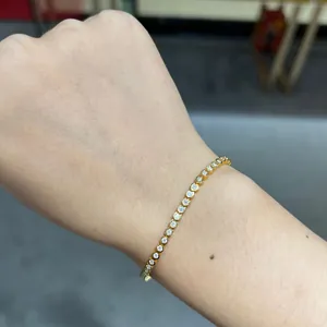 Detail shot of minimalist 1.8mm moissanite bubble bracelet on wrist in gold finish