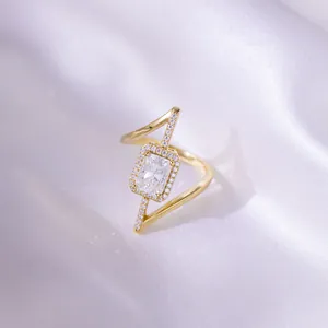 Close-up of asymmetrical gold-plated ring featuring a 2ct radiant-cut moissanite stone