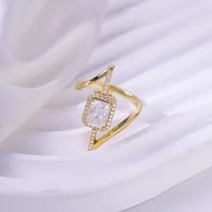 Detailed macro view of an asymmetrical gold-plated ring with radiant moissanite