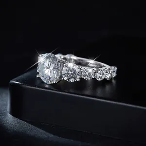 Close-up of 4 carat moissanite ring with brilliant sparkles on black background