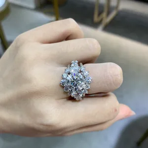 Luxurious 4-carat round moissanite ring with halo setting on a silver gold-plated band.