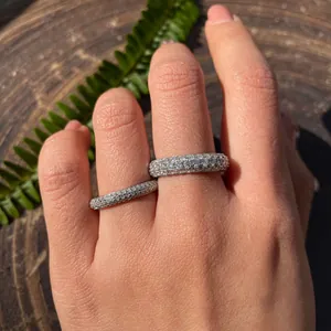 Sparkling moissanite eternity rings in two widths worn on a hand for stacking