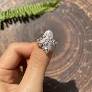 Close-up view of oval moissanite stacking ring set with star and moon decorative band